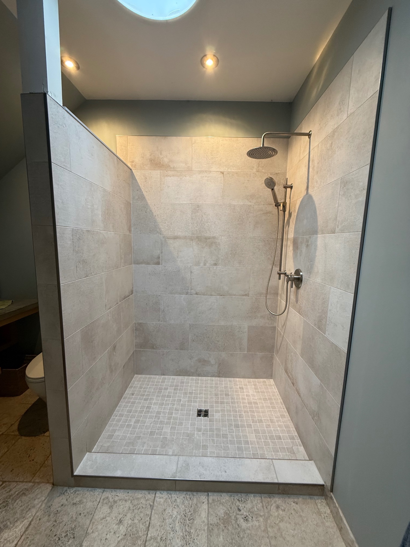 Custom stone tile walk-in shower with mosaic floor — Slocan Valley Tile Works