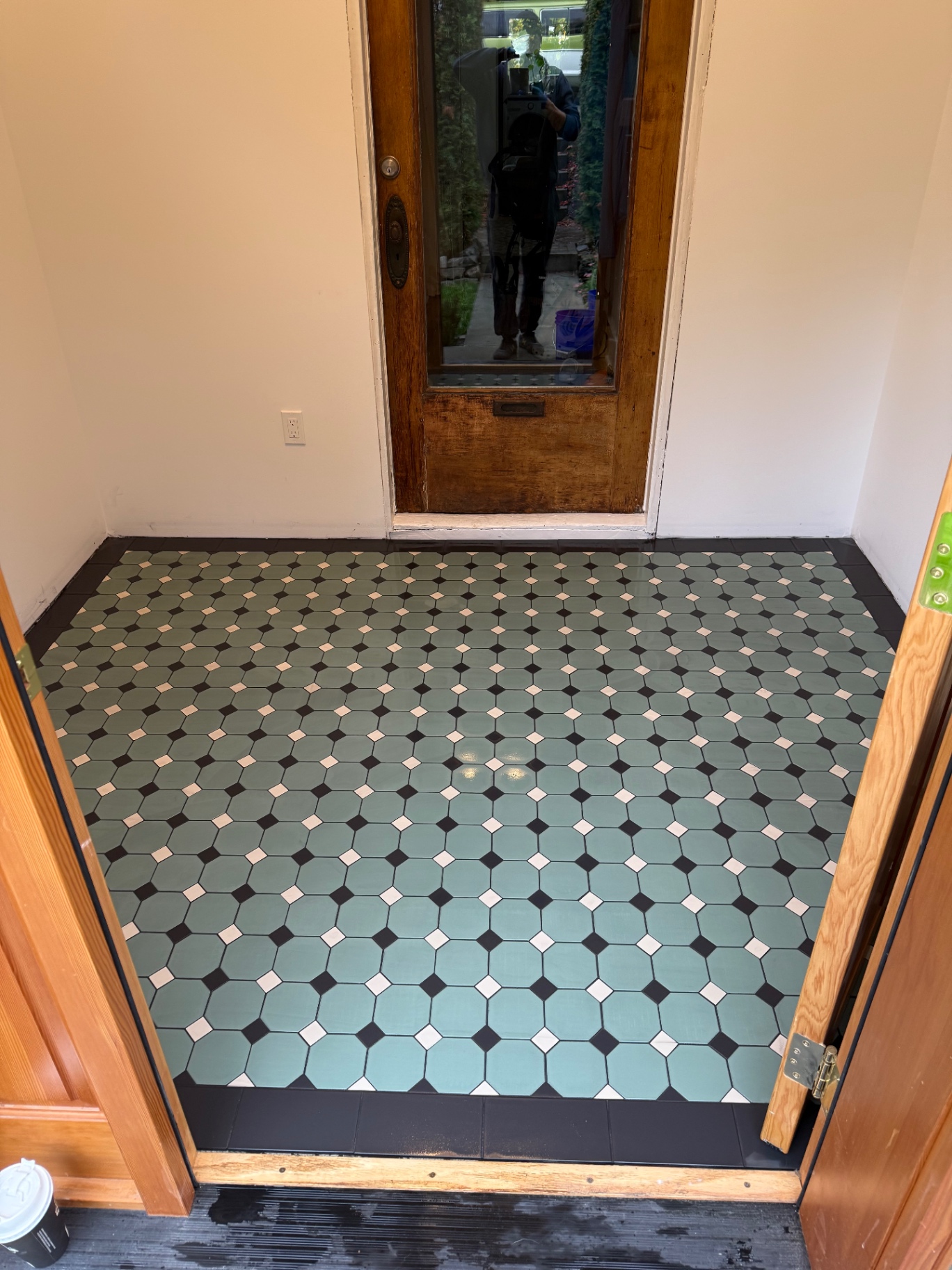 Custom green and white octagon mosaic entryway floor with dark border
